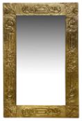 An Arts and Crafts brass embossed mirror