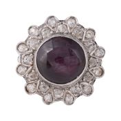 A synthetic ruby cabouchon ring with diamond border 18ct