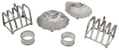 A pair of George VI Art Deco silver four division toast racks, two shell dishes and a pair of napkin