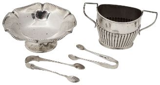 A George V silver pedestal bonbon dish, a sugar basin and sugar tongs