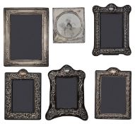 Two Edwardian silver mounted photograph frames and four modern frames