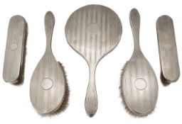 A George V silver five piece silver backed dressing table set