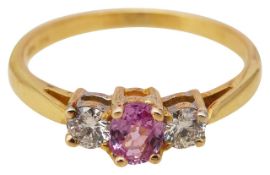 A pink sapphire and diamond three stone