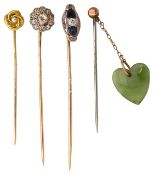 A group of four stick pins