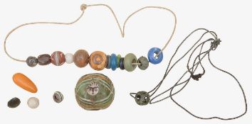 A Roman glass mosaic face bead