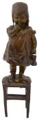 Juan Clara. A patinated bronze of a young girl standing on stool