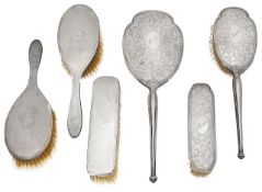 Two three piece silver backed dressing table sets