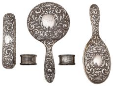 An Elizabeth II silver three piece dressing table set + a pair of napkin rings