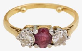A ruby and diamond three stone ring