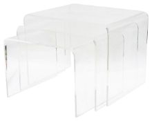 A nest of three clear acrylic occasional tables