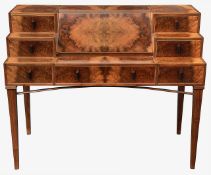 An Art Deco style burr walnut writing desk designed by Adrian Jones