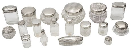 A collection silver topped dressing table jars, pots and scent bottles