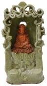 A Chinese Longquan celadon glazed and biscuit Guanyin shrine