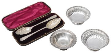 Three silver pedestal bonbon dishes and a cased pair of berry spoons