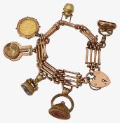 A gold charm bracelet with sovereign