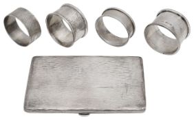 An Edwardian silver cigarette case and four napkin rings