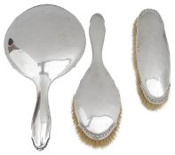 A Danish three piece planished silver dressing table set