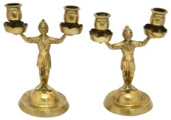 A pair of 19th century novelty brass two light soldier candlesticks
