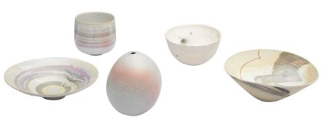 A collection of four ceramic bowls and one vase