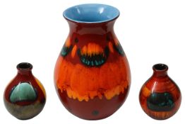A large Poole Pottery Volcano vase and two bud vases
