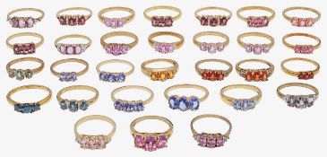 A collection of 9ct gold, three stone rings