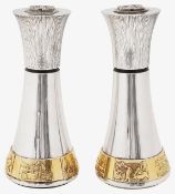A pair of large Elizabeth II Modernist silver and parcel gilt pepper mills