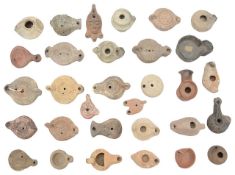 A collection of thirty one Roman and later pottery oil lamps