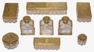 An early Victorian nine piece set of silver-gilt toilet bottles and jars