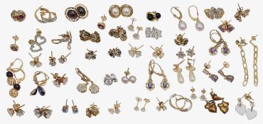 A large collection of earrings, ear-pendants and ear-studs