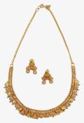 An Indian gold necklace and matching earrings