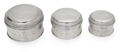 A set of three Elizabeth II graduated silver dressing table pots