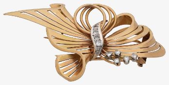 A diamond and gold bow brooch
