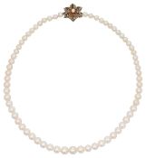 A graduated pearl necklace with garnet and seed pearl ornate flower clasp