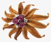A stylised gold ruby and diamond flower brooch