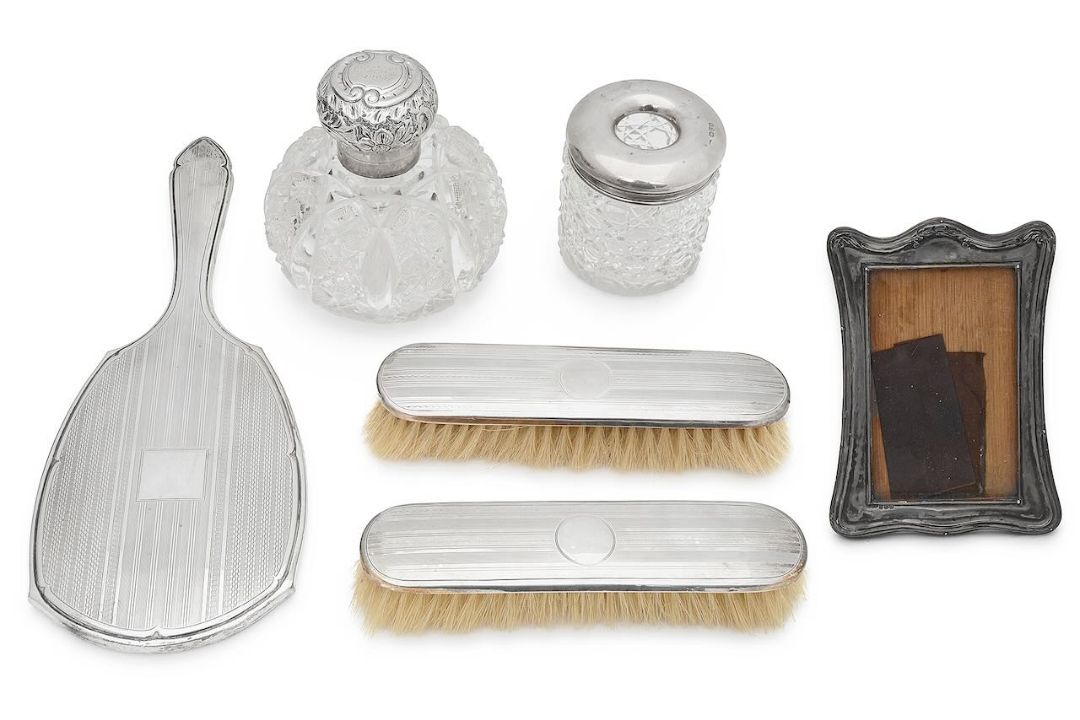 Two George V silver mounted dressing table brushes, mirror and other items
