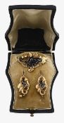 A mid Victorian gold and black enamel brooch and a pair of ear pendants