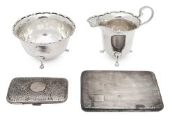 A George V silver milk jug and sugar basin and two cigarette cases