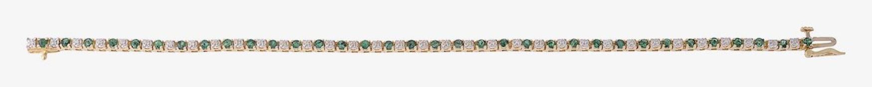 An emerald and diamond line bracelet