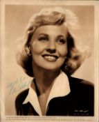 Lola Albright signed 10x8 inch vintage sepia photo with original Columbia Pictures mailing envelope.