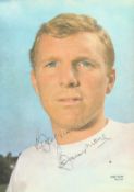 Bobby Moore signed 10x8 inch colour magazine photo pictured while on England duty. Good condition.