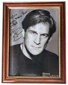 Simon MacCorkindale signed 12x10 inch overall mounted and framed black and white photo. Dedicated.