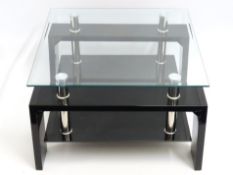 A contemporary designer style glass topped coffee