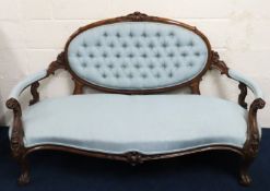 A 19thC. carved walnut upholstered button back sof