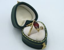 A 9ct gold ring set with marquise cut garnet, 3.2g