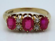 An 18ct gold ring set with ruby & diamond, centre