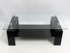 A contemporary designer style glass topped coffee