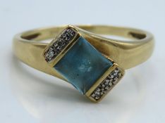 A 9ct gold ring set with diamond & princess cut aq