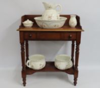 A c.1900 mahogany washstand with ceramic accessori
