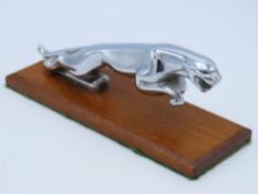 A 1960/70s Jaguar car mascot mounted on wooden pli