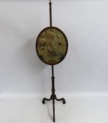 A 19thC. mahogany pole screen with finely embroide